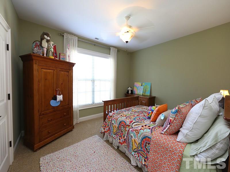12913 Baybriar Drive Raleigh, NC 27613 - Photo 17 of 25 a bedroom with a bed and window