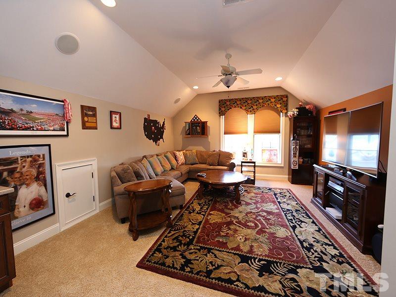 12913 Baybriar Drive Raleigh, NC 27613 - Photo 20 of 25 a living room with furniture and a flat screen tv