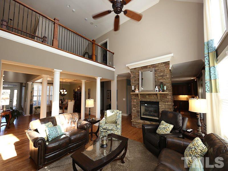 12913 Baybriar Drive Raleigh, NC 27613 - Photo 7 of 25 a living room with furniture fireplace and a flat screen tv