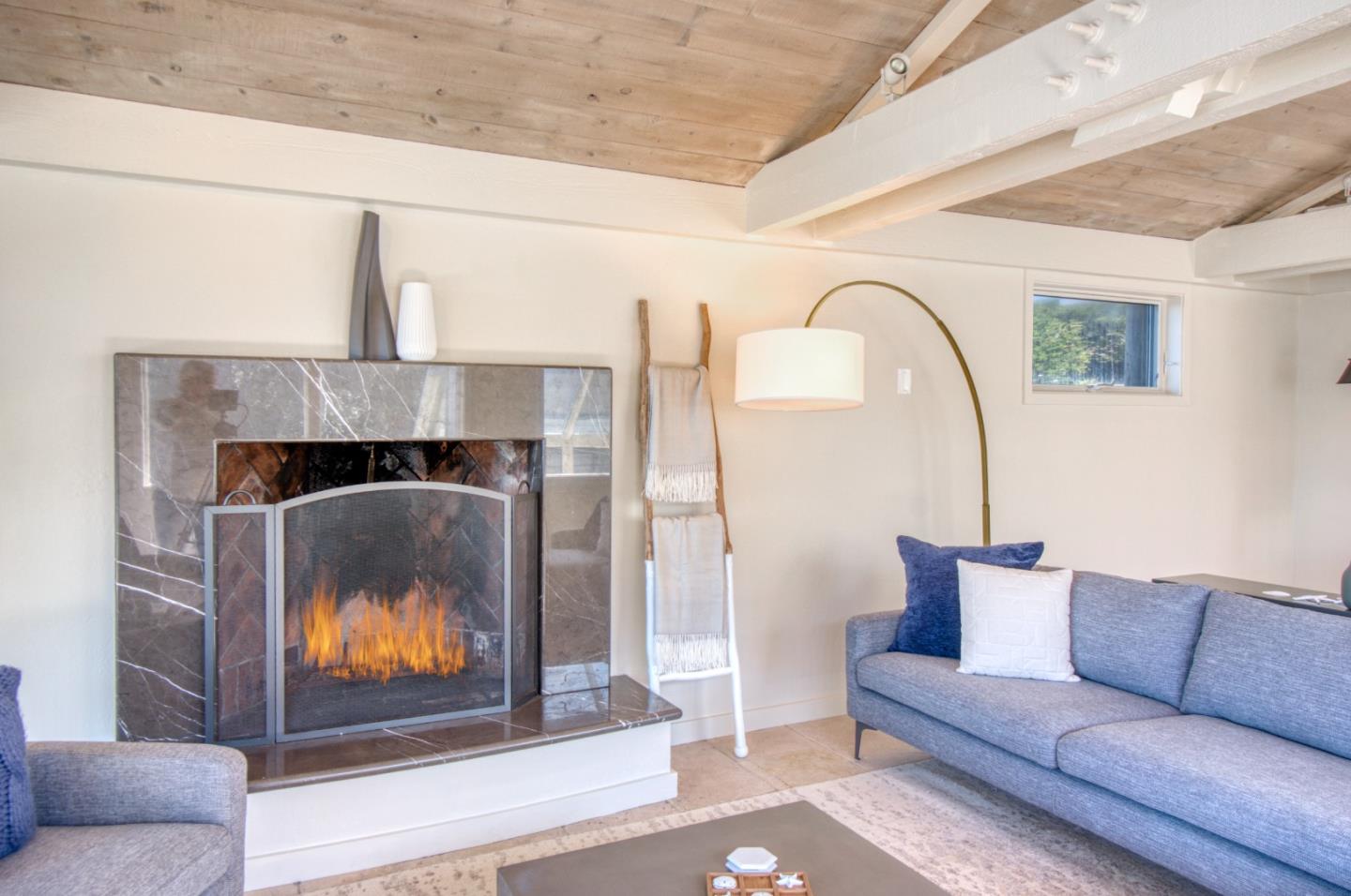 191 Reef Point Road Moss Beach, CA 94038 - Photo 13 of 41 a living room with furniture and a fireplace