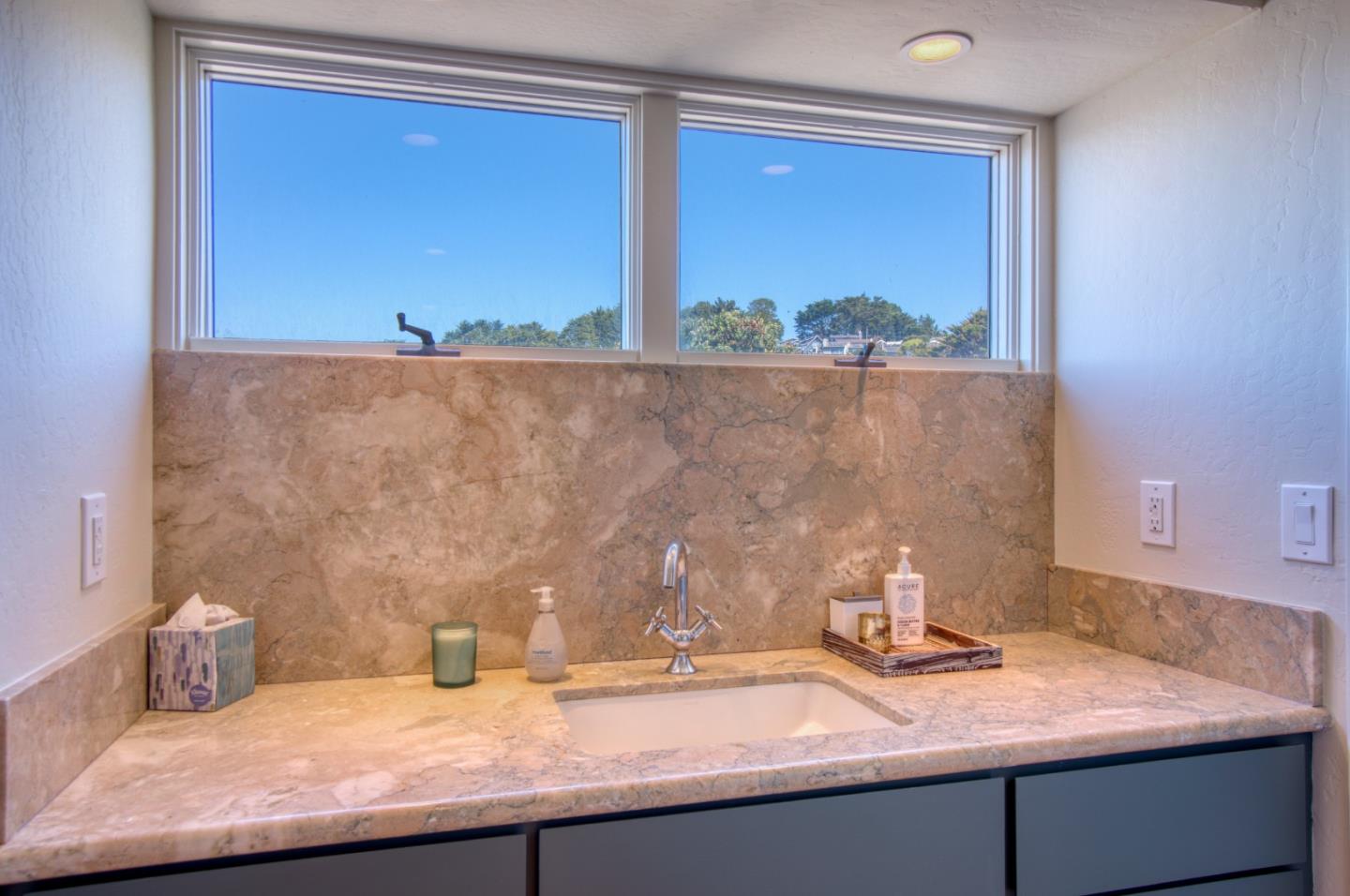 191 Reef Point Road Moss Beach, CA 94038 - Photo 19 of 41 a bathroom with a granite countertop sink and a mirror