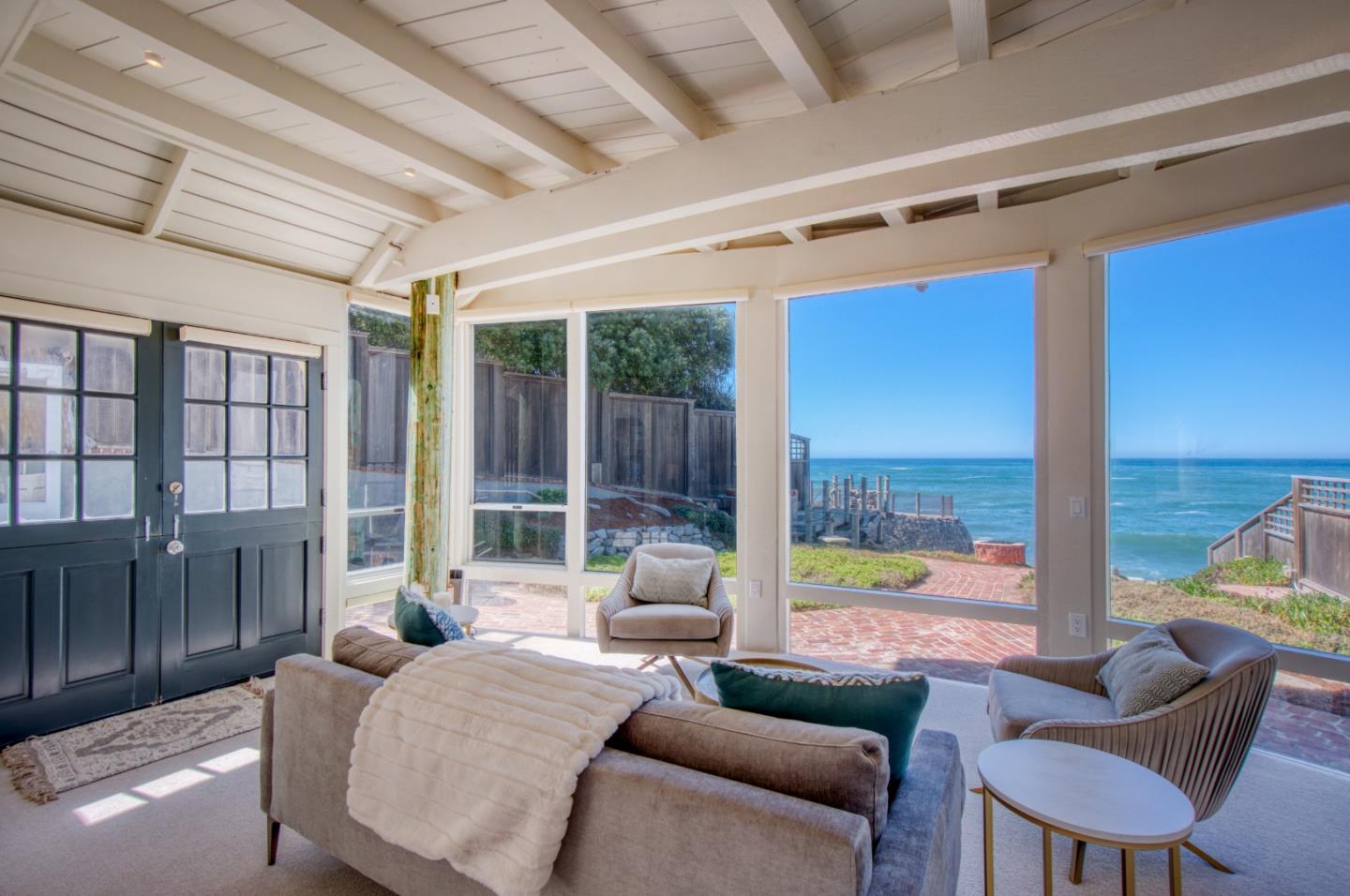 191 Reef Point Road Moss Beach, CA 94038 - Photo 24 of 41 a living room with furniture and a floor to ceiling window