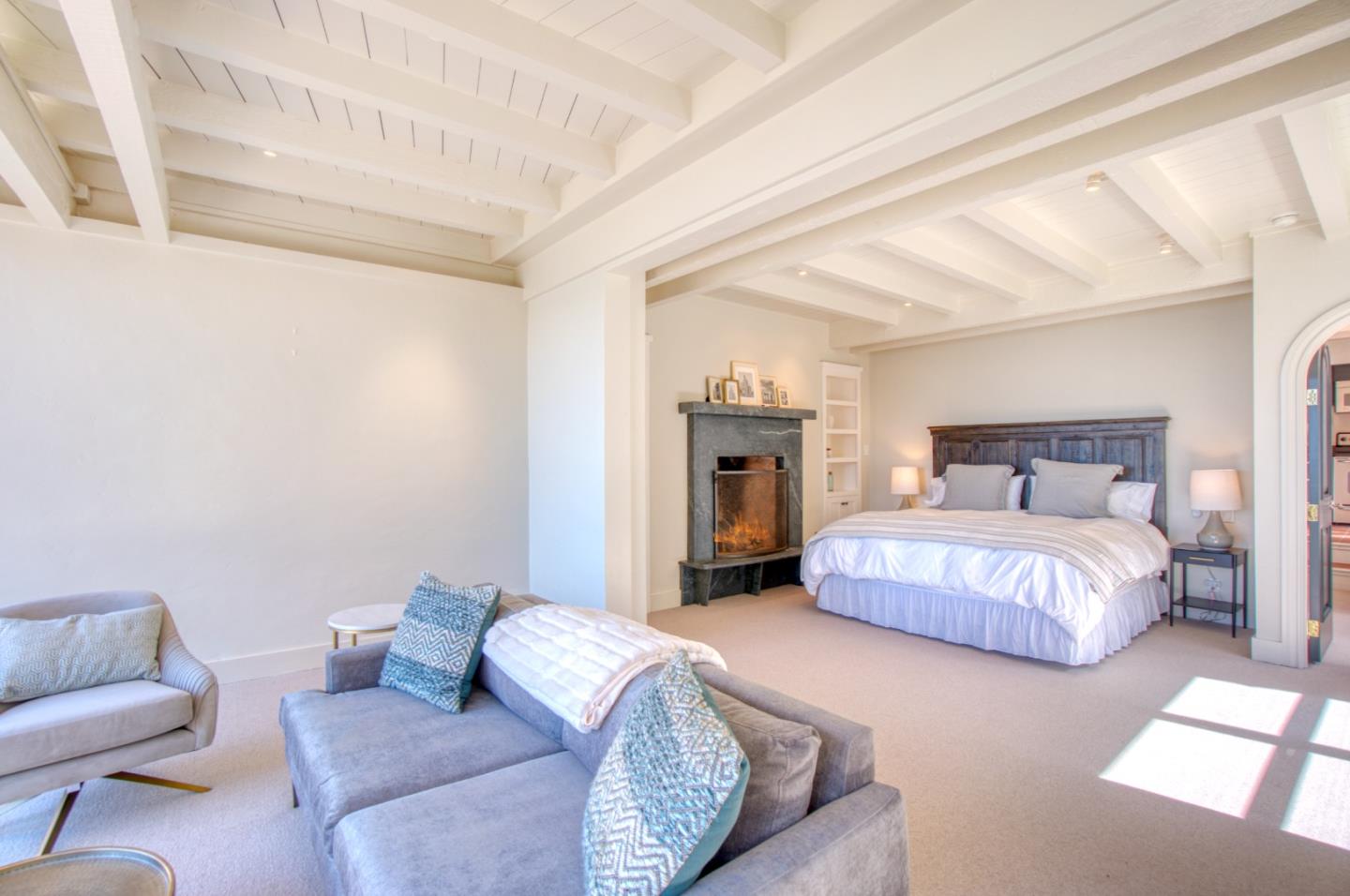 191 Reef Point Road Moss Beach, CA 94038 - Photo 26 of 41 a spacious bedroom with a bed and couch