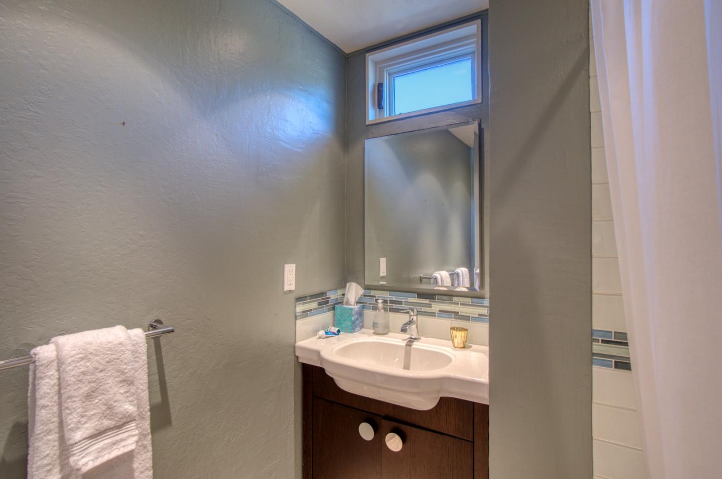 191 Reef Point Road Moss Beach, CA 94038 - Photo 29 of 41 a bathroom with a sink and a mirror