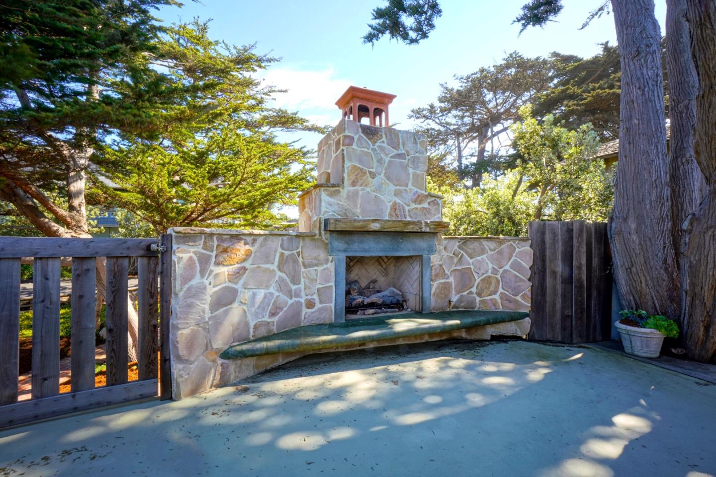 191 Reef Point Road Moss Beach, CA 94038 - Photo 31 of 41 a view of a building with a tree in front of it