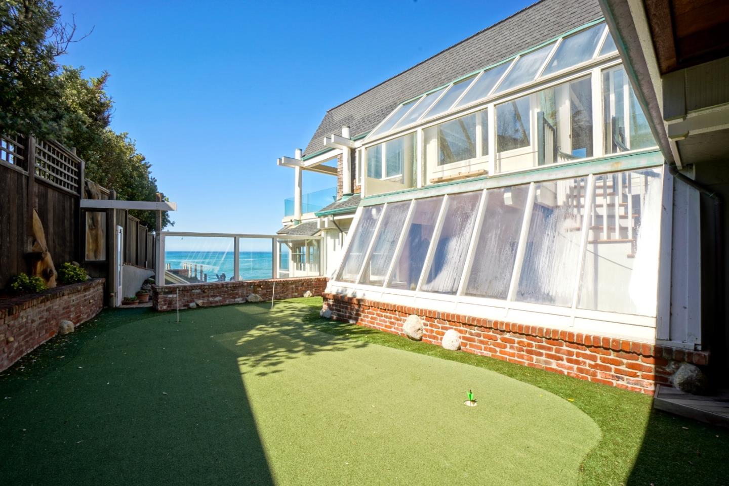 191 Reef Point Road Moss Beach, CA 94038 - Photo 32 of 41 a front view of a house with a garden