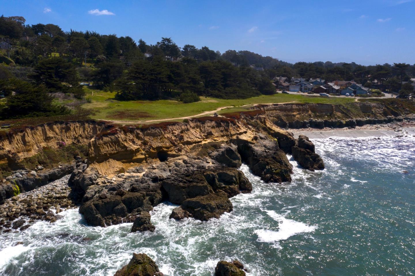 191 Reef Point Road Moss Beach, CA 94038 - Photo 38 of 41 a view of a town with mountains in the background