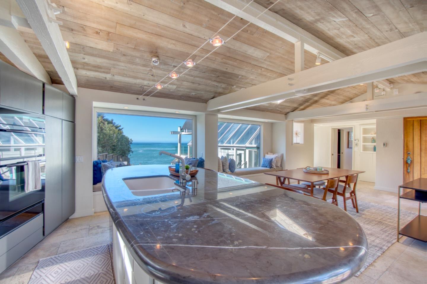 191 Reef Point Road Moss Beach, CA 94038 - Photo 5 of 41 a view of a dining room with furniture window and wooden floor