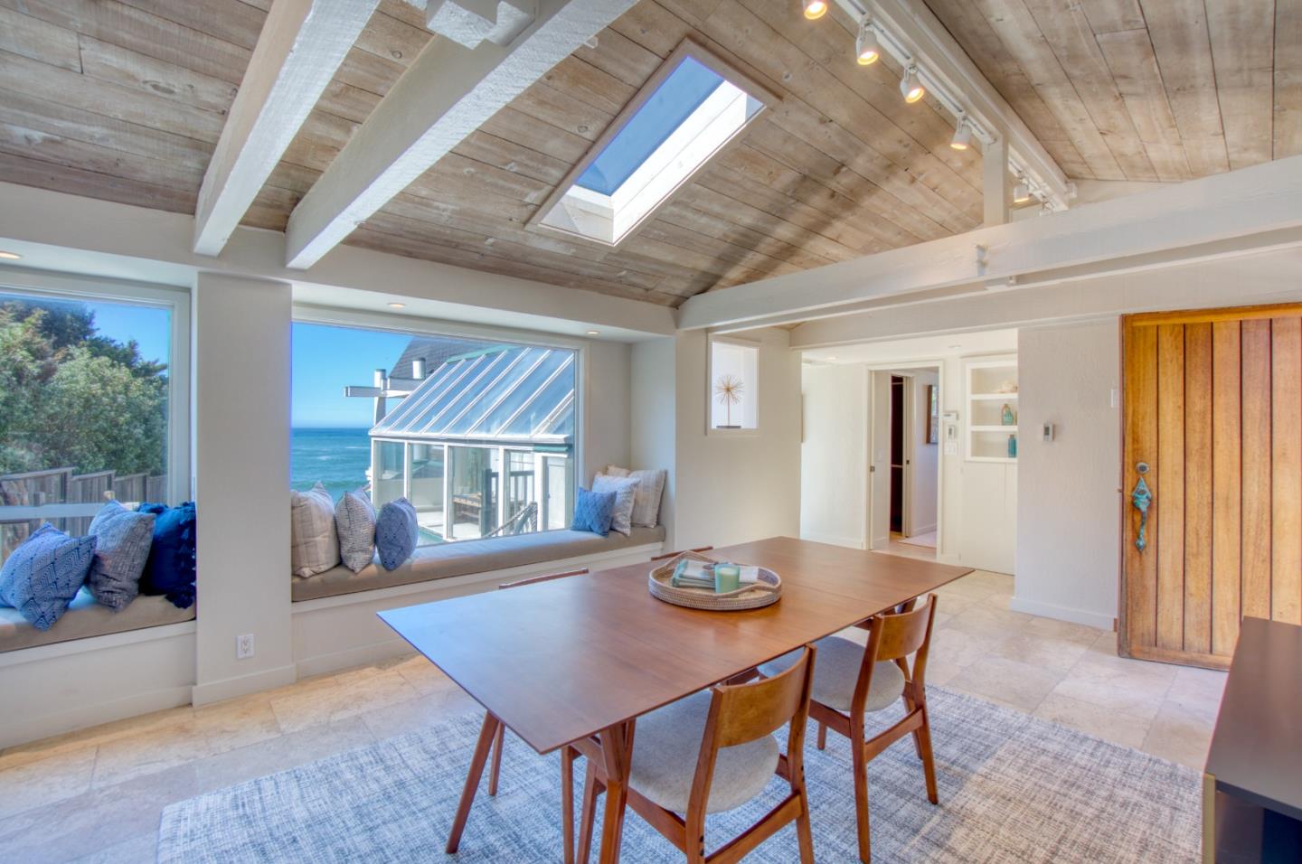 191 Reef Point Road Moss Beach, CA 94038 - Photo 7 of 41 a view of a dining room with furniture and wooden floor