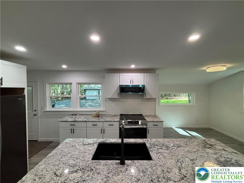 250 Bird Lane Kunkletown, PA 18058 - Photo 12 of 40 a kitchen with a stove a sink and a refrigerator