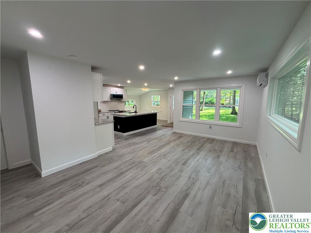 250 Bird Lane Kunkletown, PA 18058 - Photo 14 of 40 an empty room with wooden floor and windows