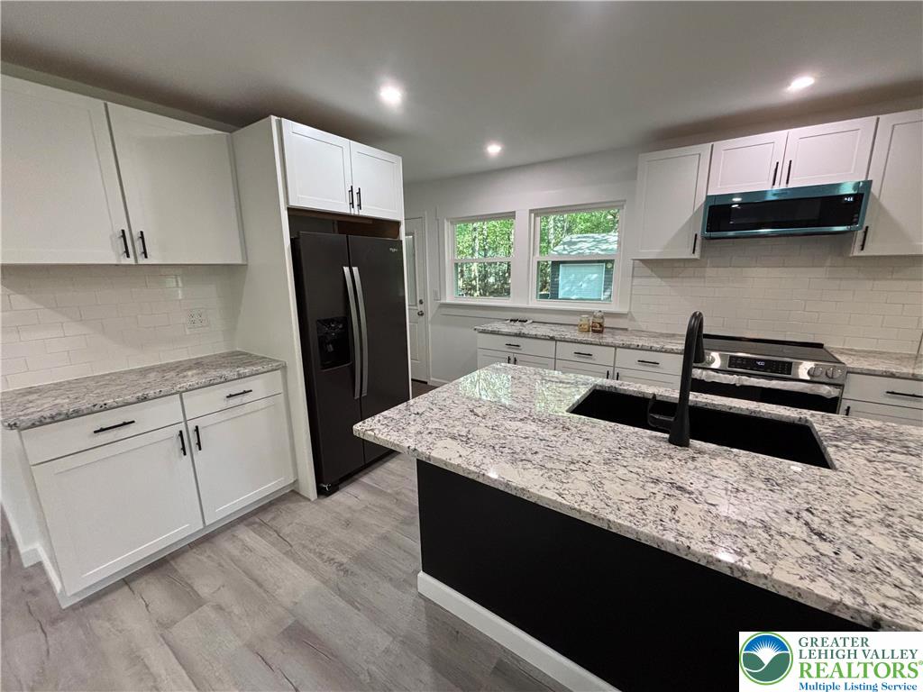 250 Bird Lane Kunkletown, PA 18058 - Photo 5 of 40 a kitchen with stainless steel appliances granite countertop a sink stove and refrigerator