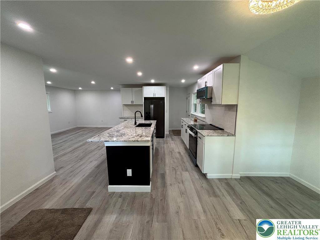 250 Bird Lane Kunkletown, PA 18058 - Photo 8 of 40 a kitchen with a sink and a stove top oven