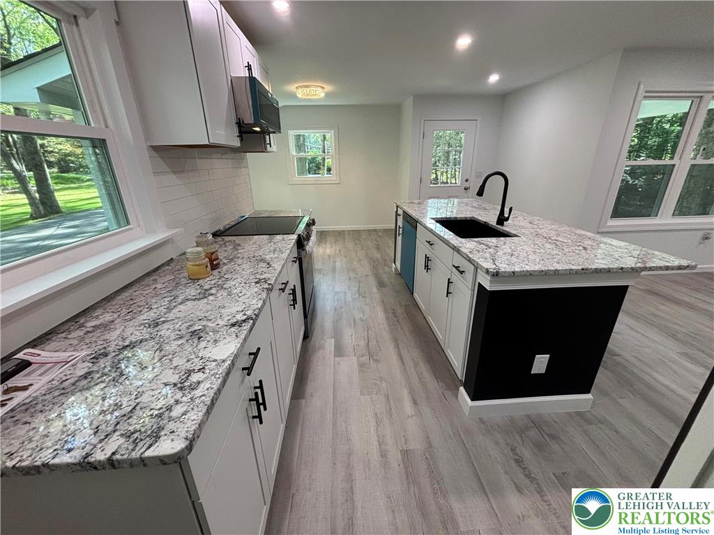 250 Bird Lane Kunkletown, PA 18058 - Photo 9 of 40 a kitchen with a sink stove and cabinets
