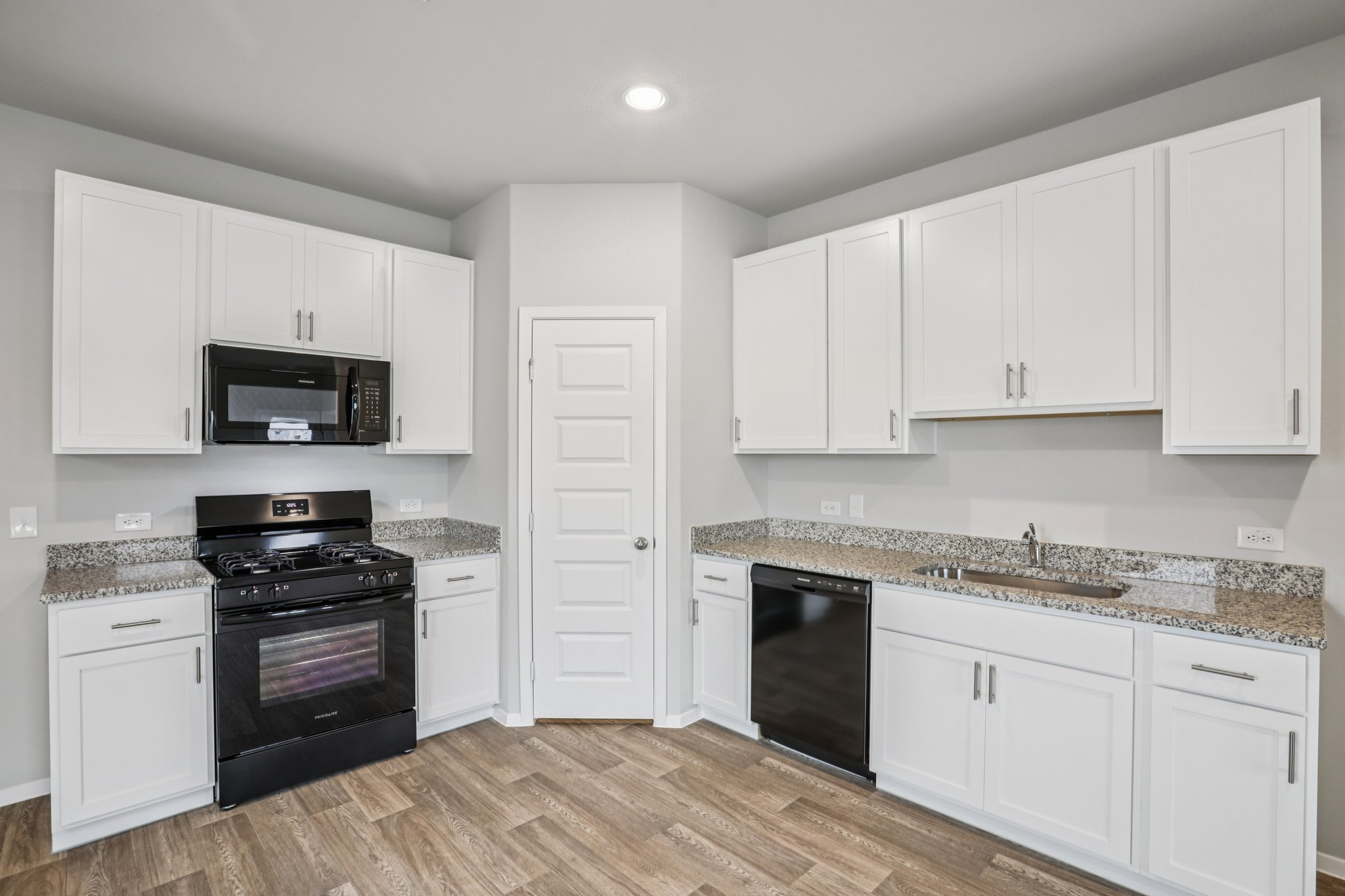 104 Summer Drive Elgin, TX 78621 - Photo 9 of 40 a kitchen with granite countertop white cabinets and stainless steel appliances