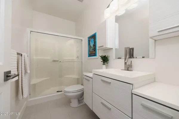a bathroom with a sink toilet and shower