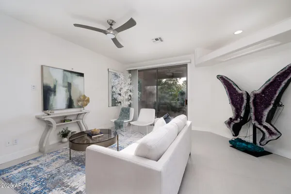a living room with furniture a air conditioner and a window