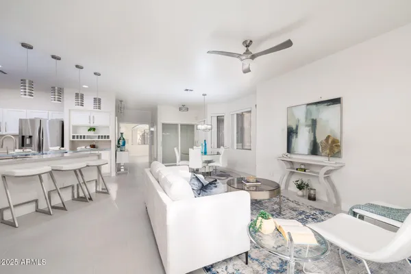 a living room with furniture and view of kitchen