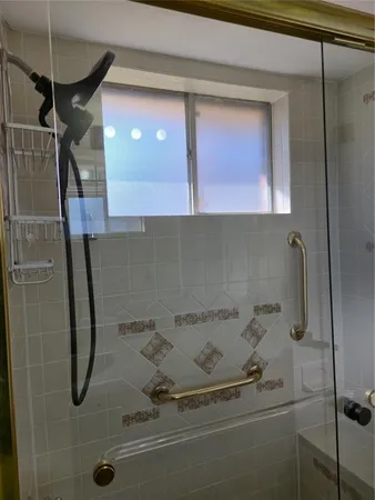 a bathroom with a shower and a mirror