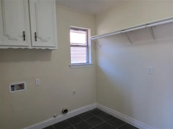 a view of storage and utility room with closet