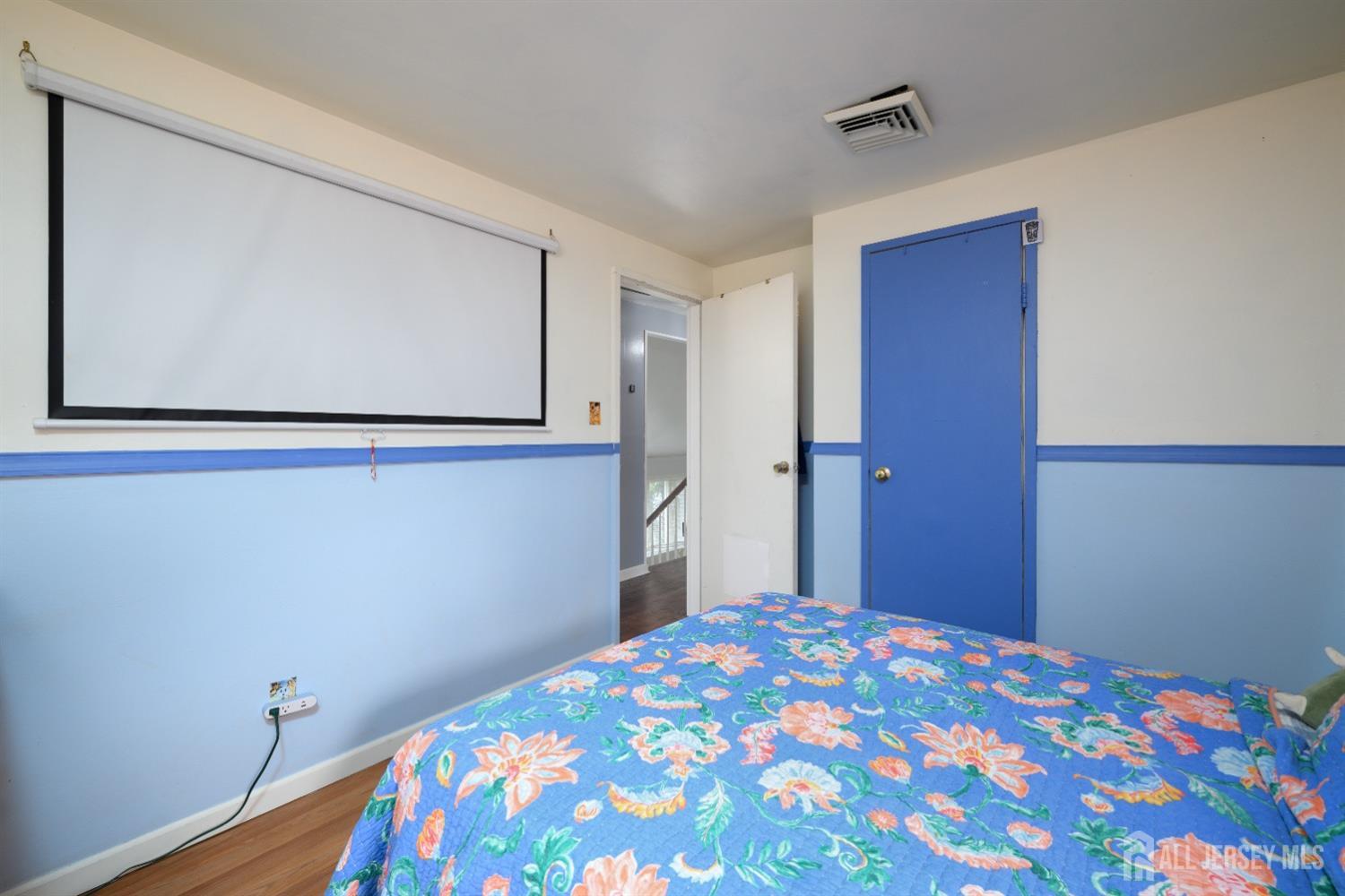 109 Hickory Road Colonia, NJ 07067 - Photo 12 of 34 a bedroom with a bed and wooden floor