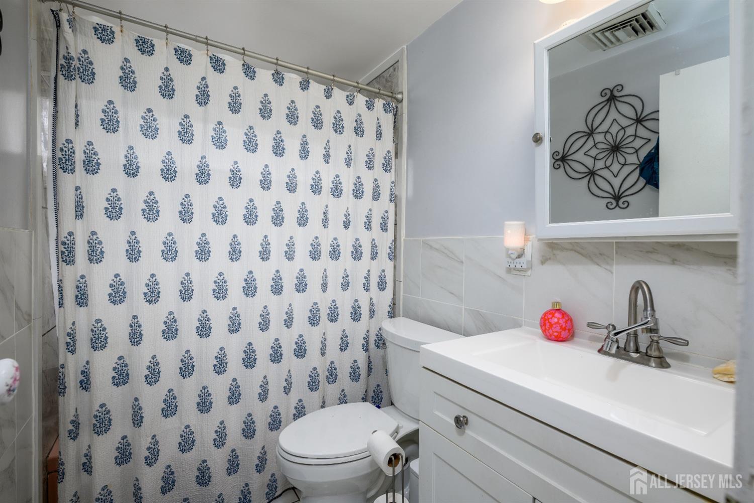 109 Hickory Road Colonia, NJ 07067 - Photo 13 of 34 a bathroom with a sink and a toilet
