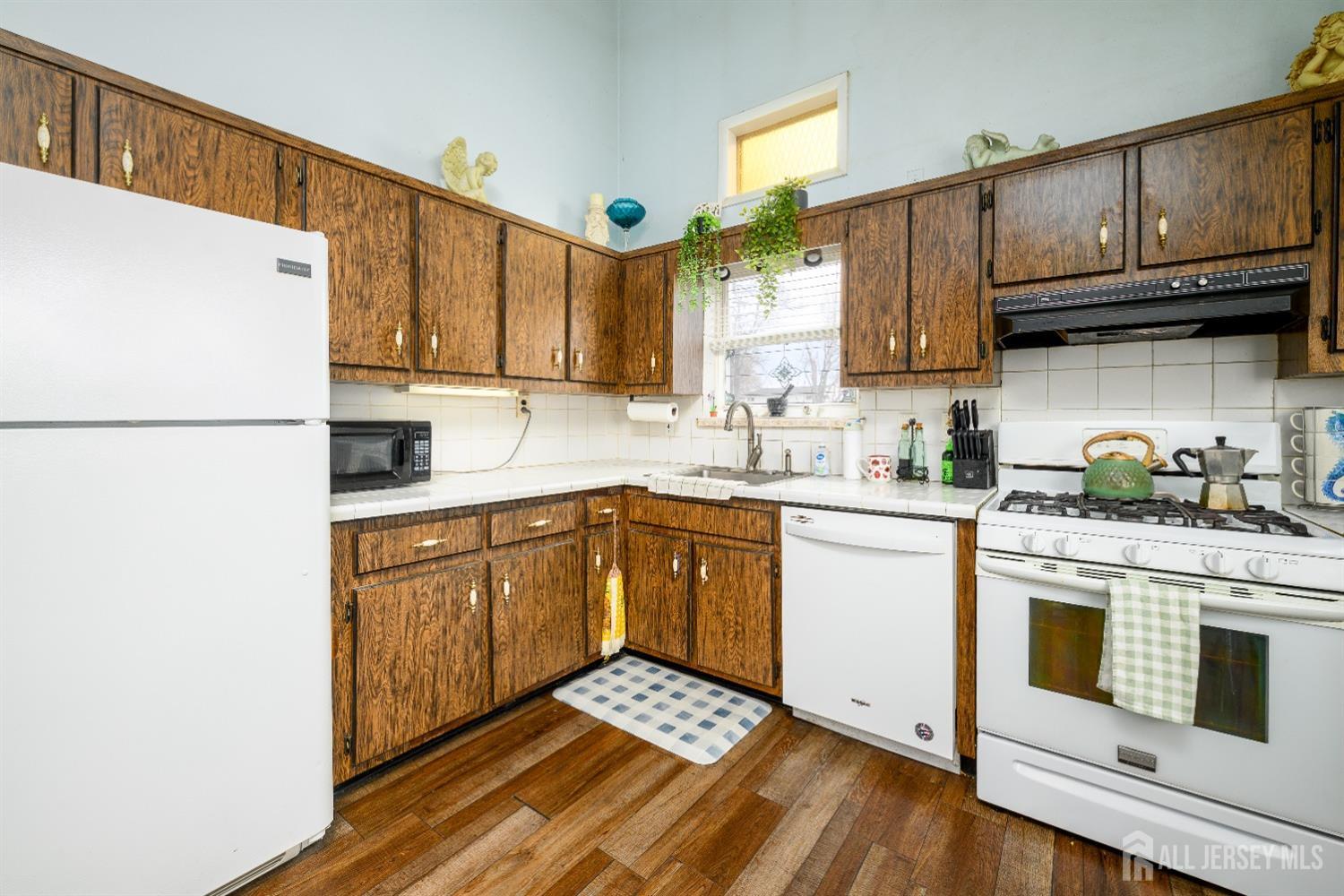 109 Hickory Road Colonia, NJ 07067 - Photo 16 of 34 a kitchen with stainless steel appliances granite countertop a refrigerator sink stove and microwave