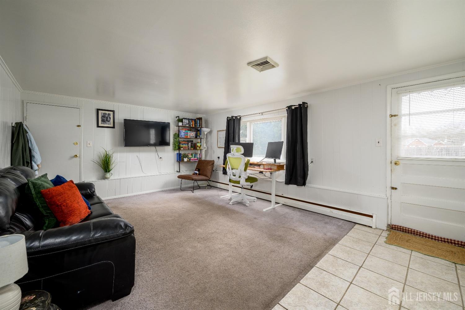 109 Hickory Road Colonia, NJ 07067 - Photo 18 of 34 a living room with furniture and a flat screen tv