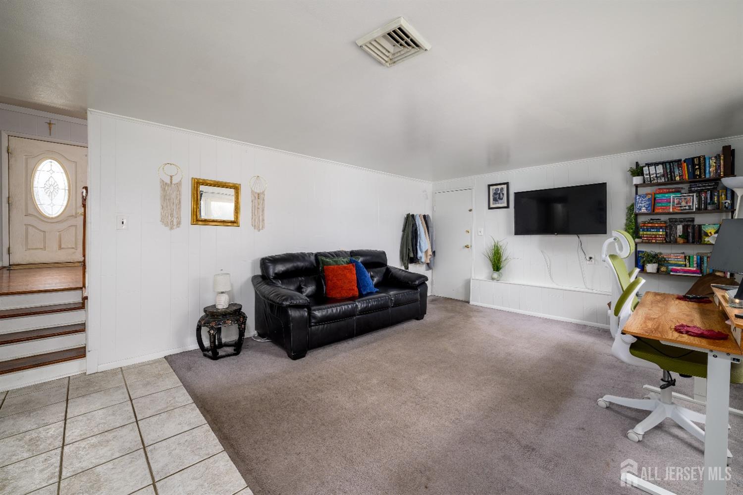 109 Hickory Road Colonia, NJ 07067 - Photo 19 of 34 a living room with furniture and a flat screen tv