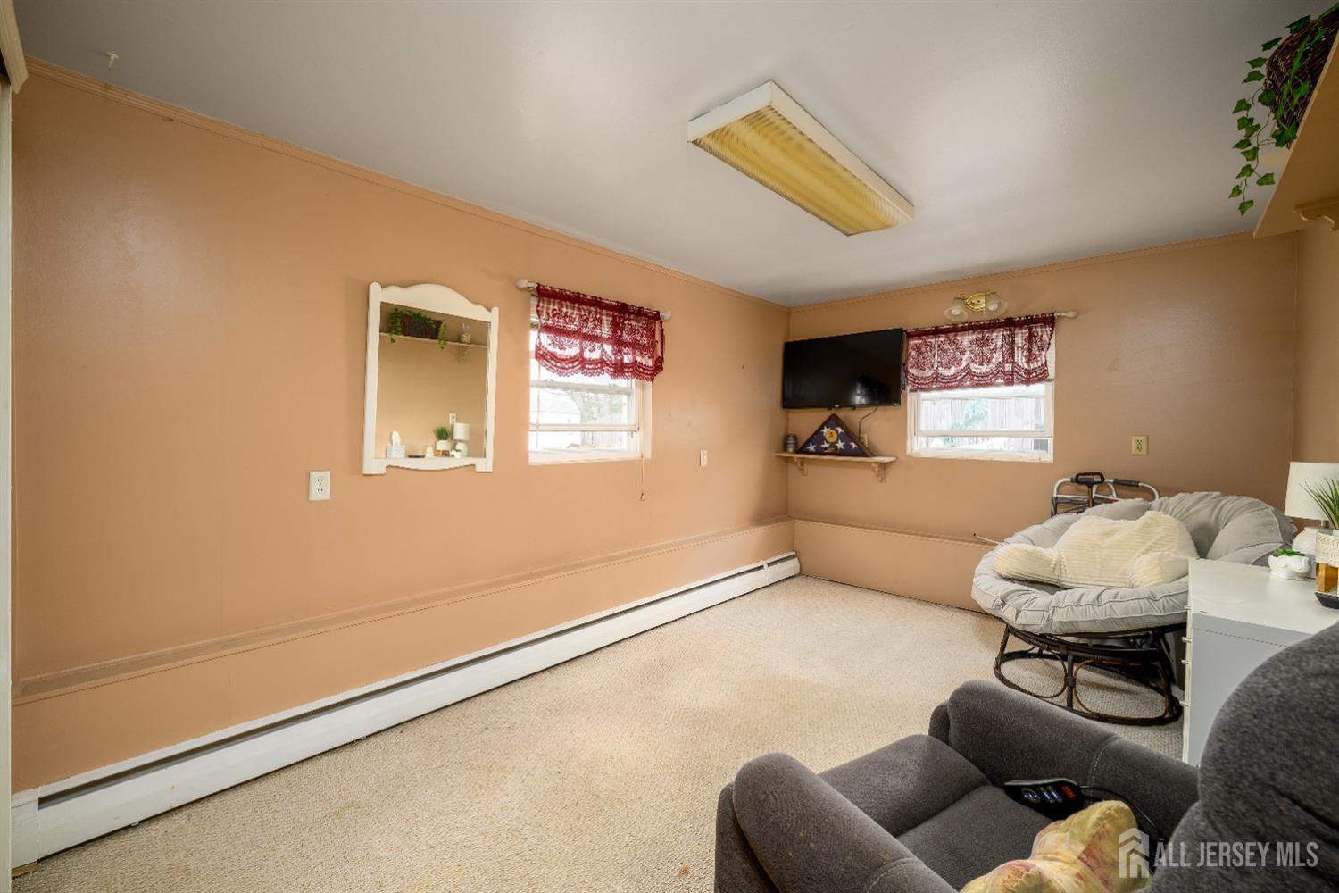 109 Hickory Road Colonia, NJ 07067 - Photo 22 of 34 a living room with furniture and a flat screen tv