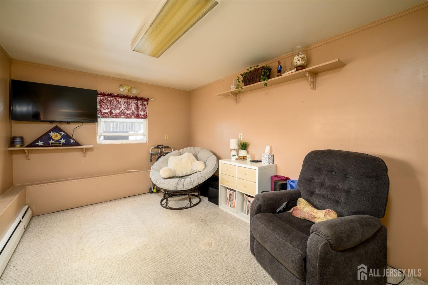 109 Hickory Road Colonia, NJ 07067 - Photo 23 of 34 a living room with furniture and a flat screen tv