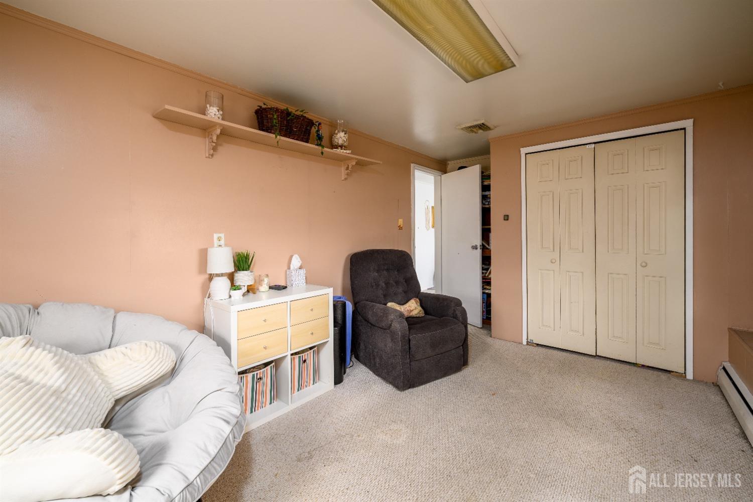 109 Hickory Road Colonia, NJ 07067 - Photo 24 of 34 a living room with furniture and a air conditioner vent