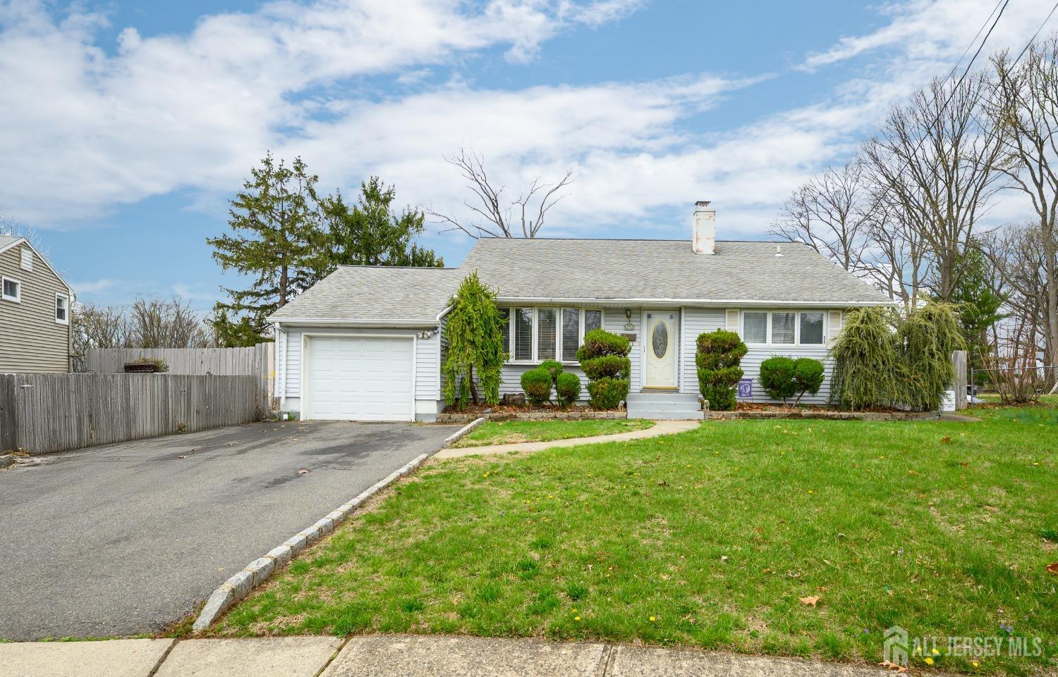 109 Hickory Road Colonia, NJ 07067 - Photo 29 of 34 a front view of a house with a yard and garage