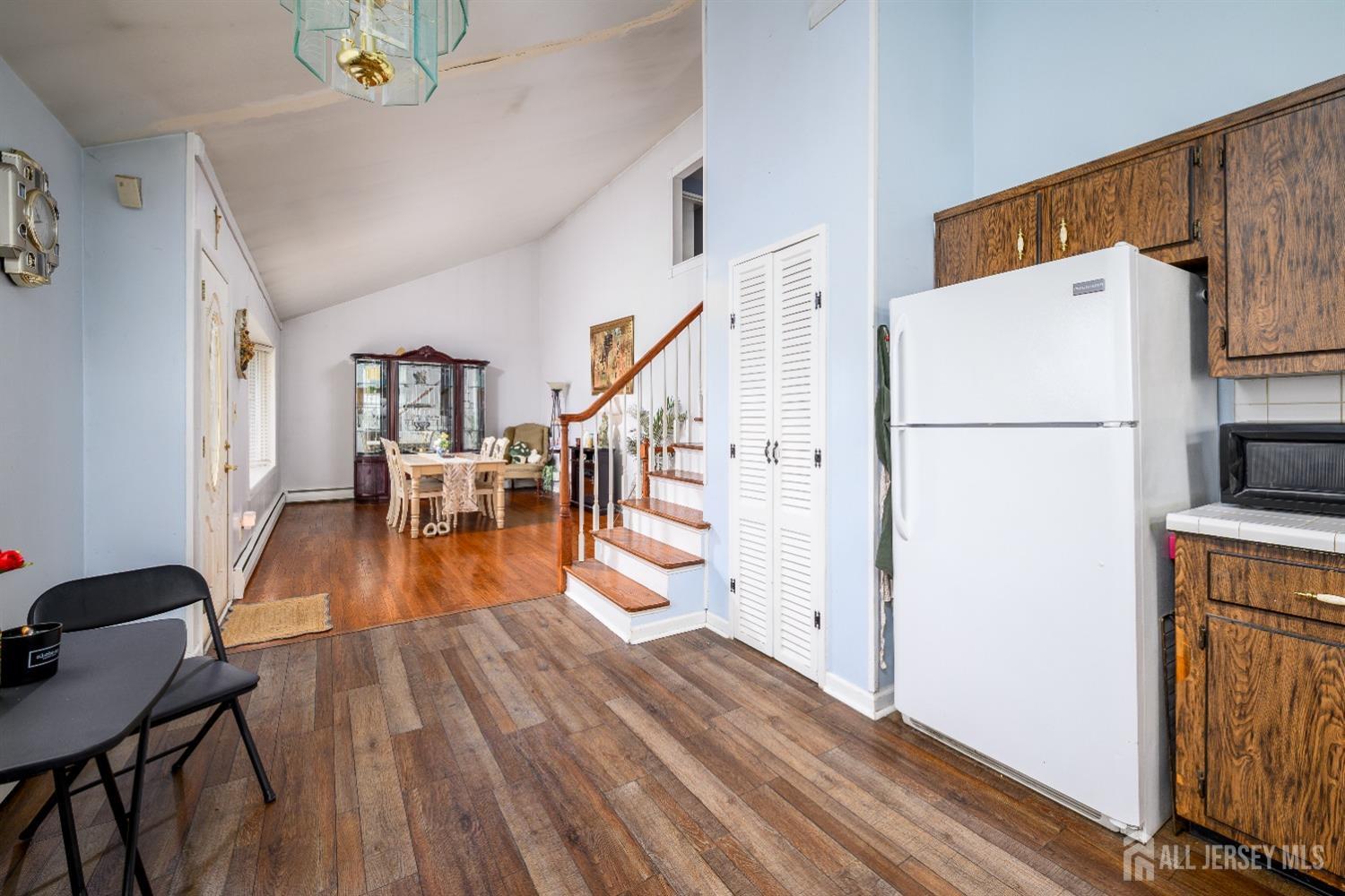 109 Hickory Road Colonia, NJ 07067 - Photo 3 of 34 a view of kitchen and dining room with wooden floor