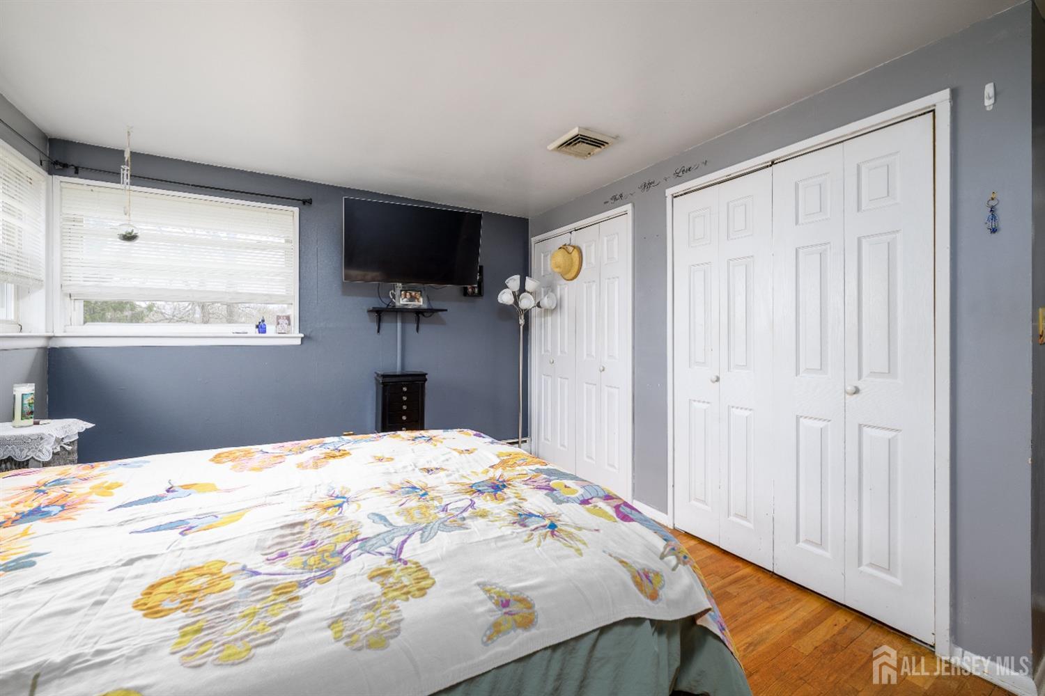 109 Hickory Road Colonia, NJ 07067 - Photo 9 of 34 a bedroom with a bed and a flat tv screen