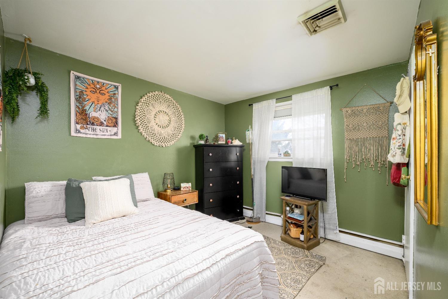 109 Hickory Road Colonia, NJ 07067 - Photo 10 of 34 a bedroom with a bed and a television