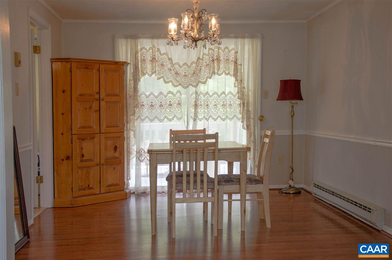 230 Ridge Street Lovingston, VA 22949 - Photo 7 of 37 a view of a dining room with furniture a chandelier and wooden floor