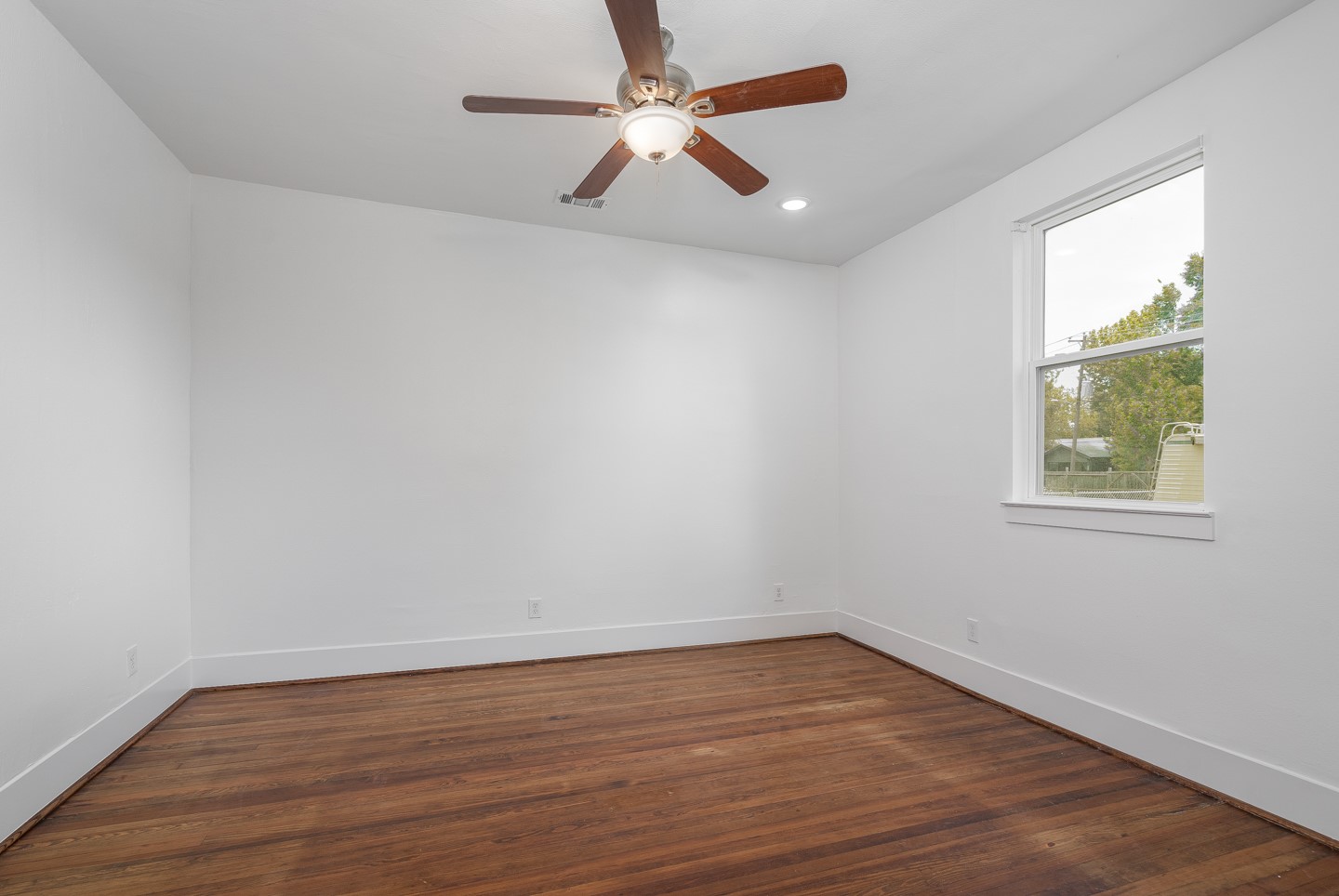 2311 Lee Street Houston, TX 77026 - Photo 12 of 24 wooden floor in an empty room with a window