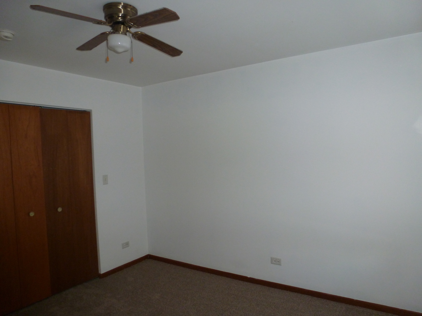 16212 Trumbull Avenue Markham, IL 60428 - Photo 23 of 36 an empty room with a ceiling fan and a window