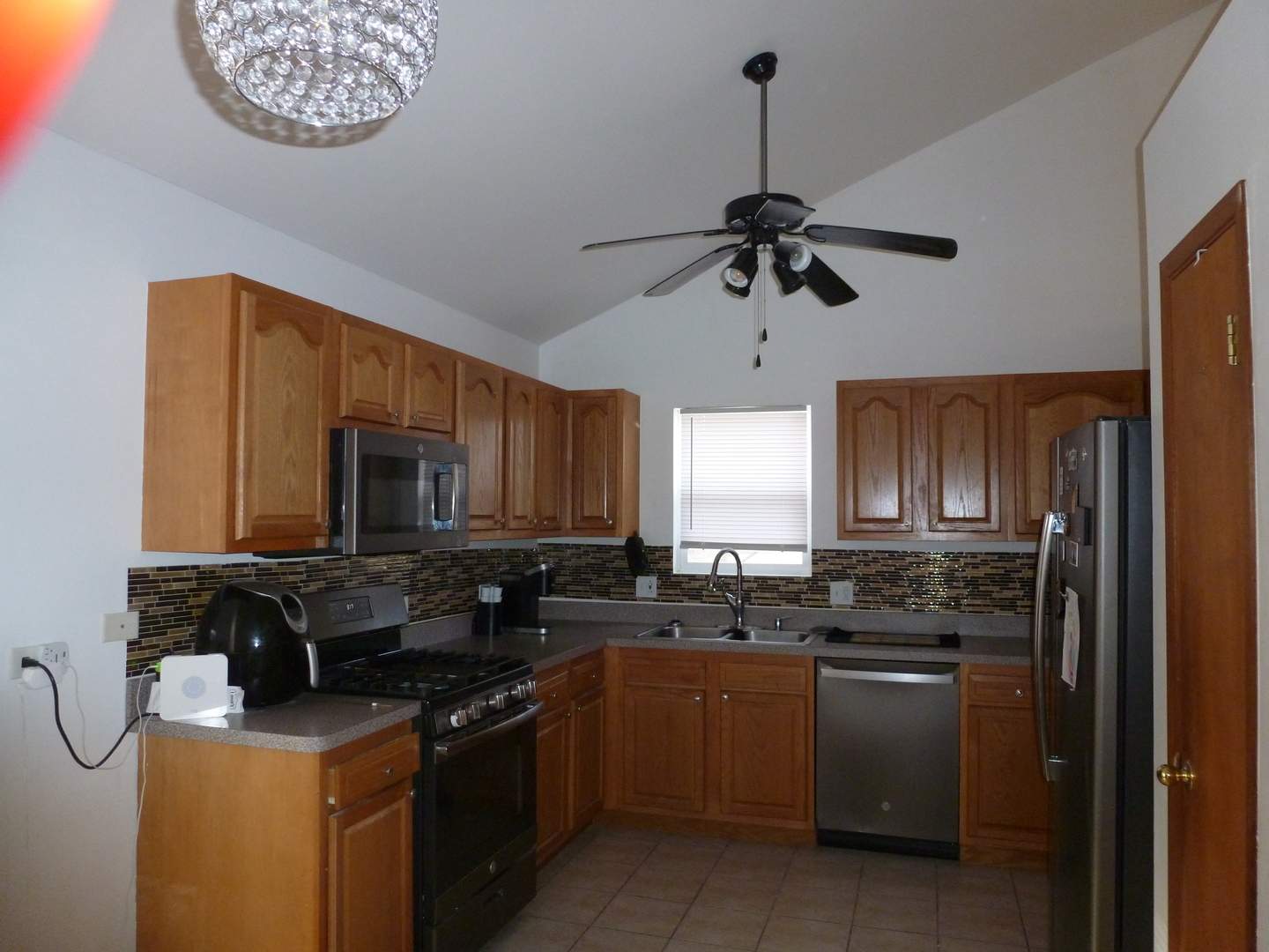 16212 Trumbull Avenue Markham, IL 60428 - Photo 26 of 36 a kitchen with stainless steel appliances granite countertop a stove sink microwave and window