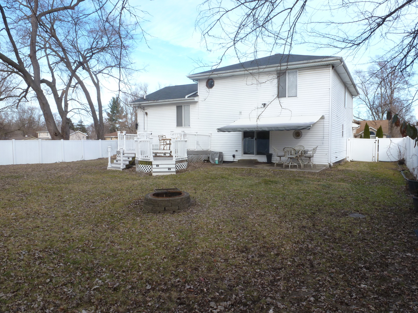16212 Trumbull Avenue Markham, IL 60428 - Photo 33 of 36 a view of a white house that has a small yard and large trees