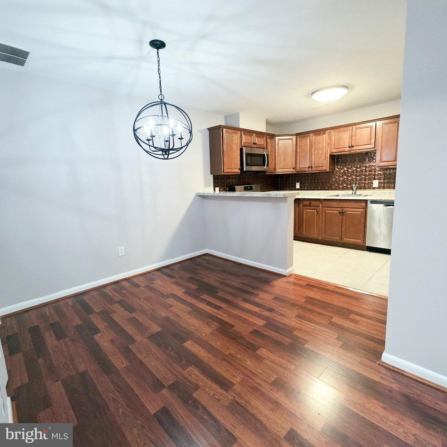 208 Ashley Run Voorhees, NJ 08043 - Photo 10 of 23 a kitchen with stainless steel appliances granite countertop a refrigerator a stove top oven a sink and dishwasher with wooden floor