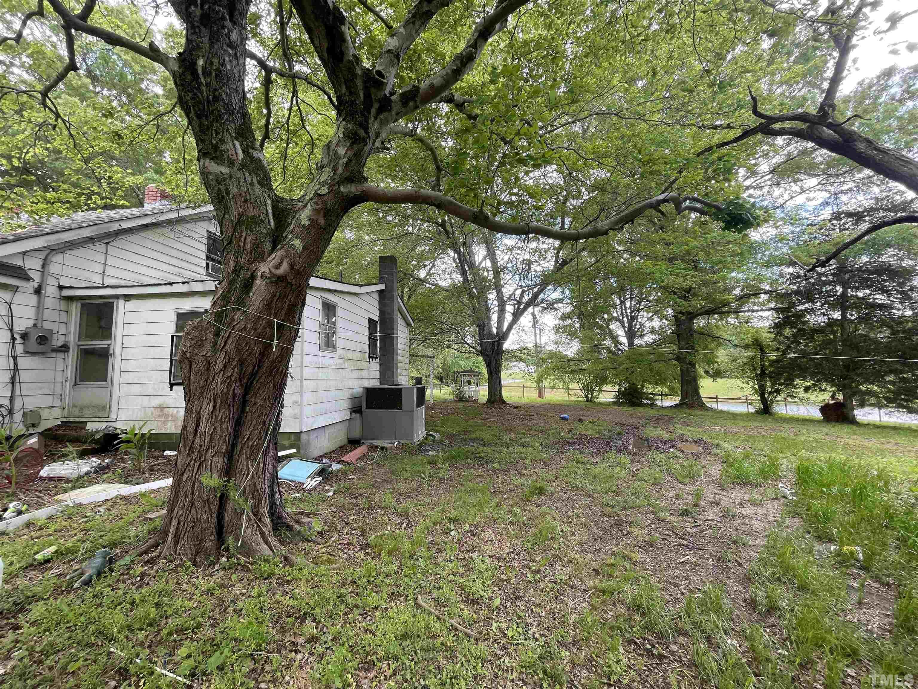 755 Kermit Duncan Road Timberlake, NC 27583 - Photo 3 of 19 a tree in the middle of a yard