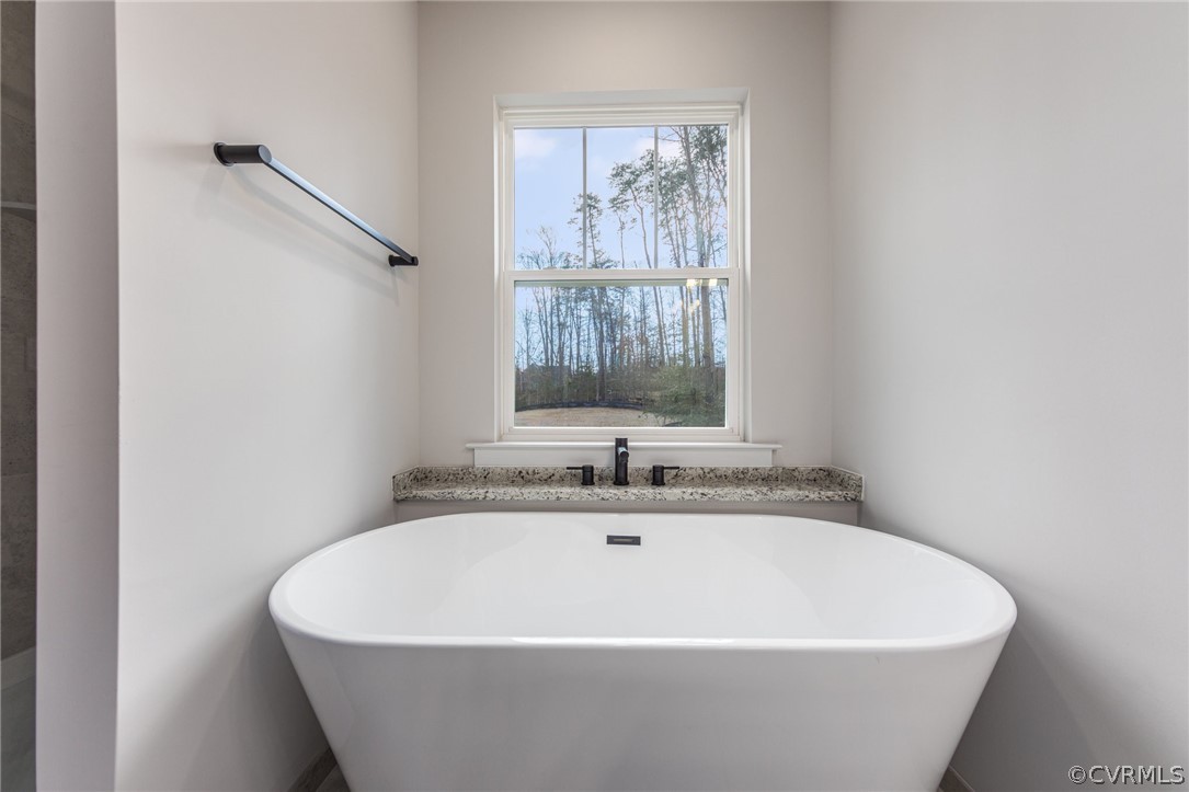 9219 Pine Stake Road Rhoadesville, VA 22542 - Photo 15 of 28 a white bath tub sitting in a bathroom