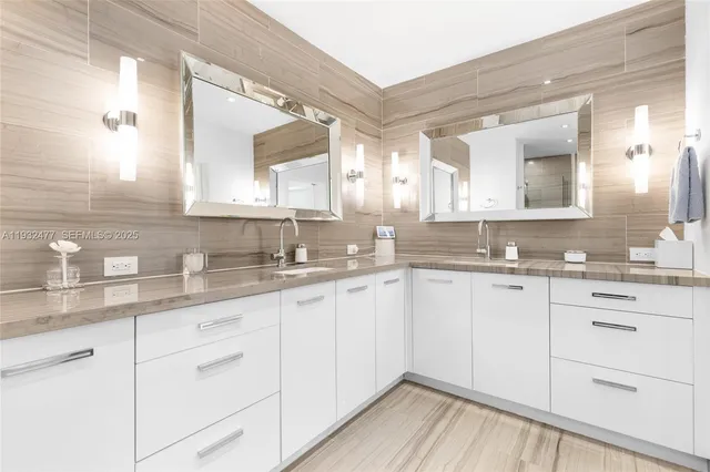 a bathroom with a granite countertop sink a toilet and shower