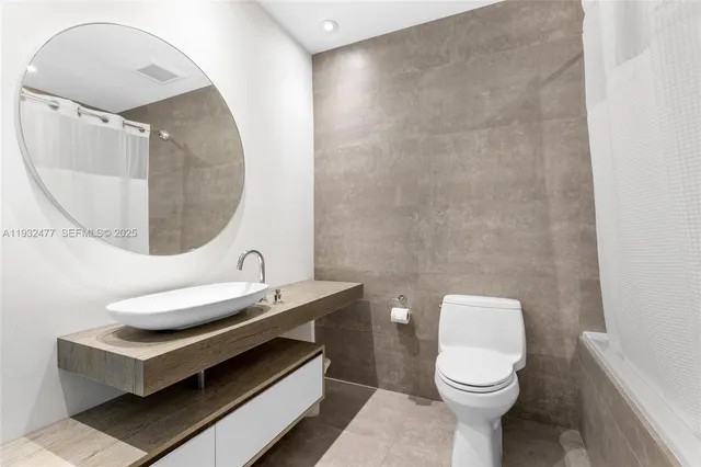 a living room with furniture and a baby crib