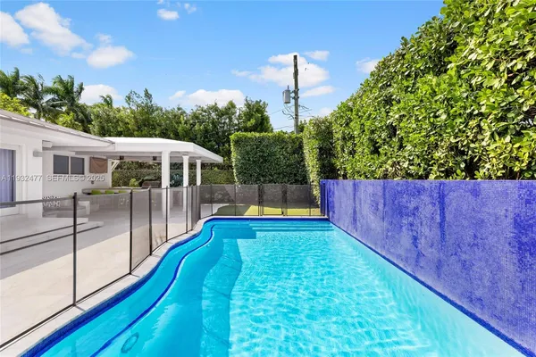 a view of a backyard with sitting area