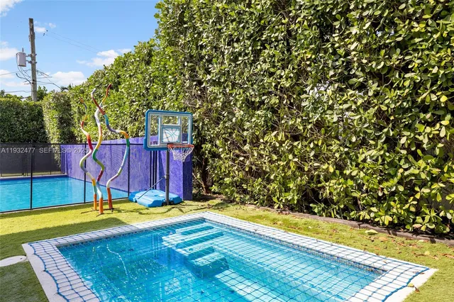 a view of a park with iron fence