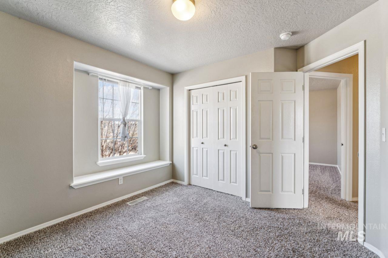 5410 Barkley Way Caldwell, ID 83607 - Photo 32 of 50 Unfurnished bedroom featuring carpet floors, a textured ceiling, and a closet