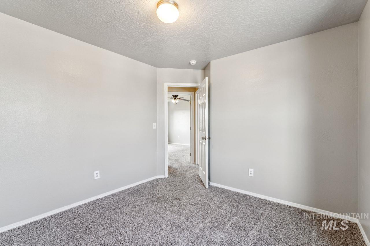 5410 Barkley Way Caldwell, ID 83607 - Photo 34 of 50 Carpeted empty room featuring baseboards and a textured ceiling